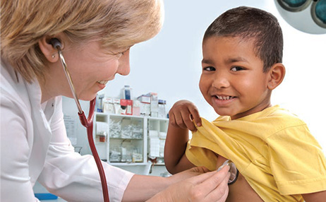 Doctor checking heartbeat of a kid