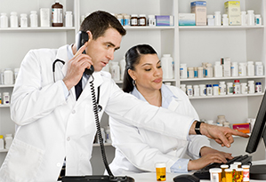 Stock image pharmacist with assistant