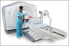 woman helping patient with CT scanner