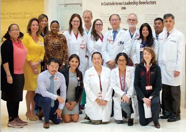 A group of doctors and healthcare professionals posing for a photo