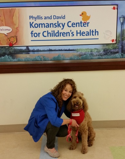 Woman posing for photo with therapy dog