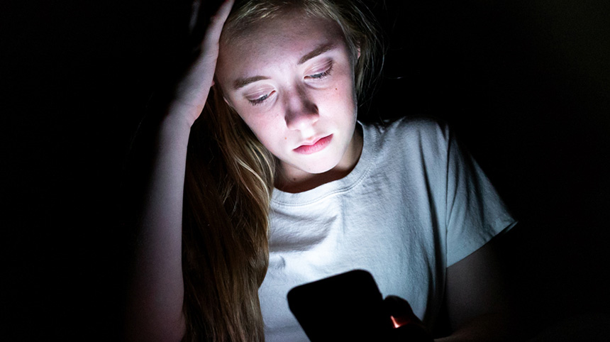 girl on phone in the dark