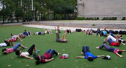 A group of children laying in a circle exercising