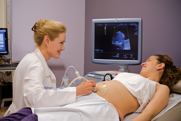 Dr. Lynn L. Simpson with a pregnant mom