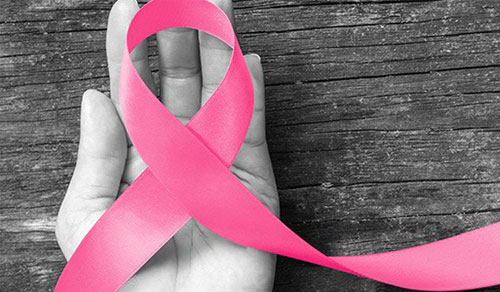 pink ribbon over a hand
