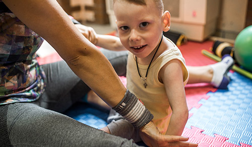 image of young boy with cerebral palsy having musculoskeletal therapy