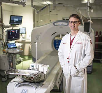 Dr. Timothy McClure standing in front of Ct machine