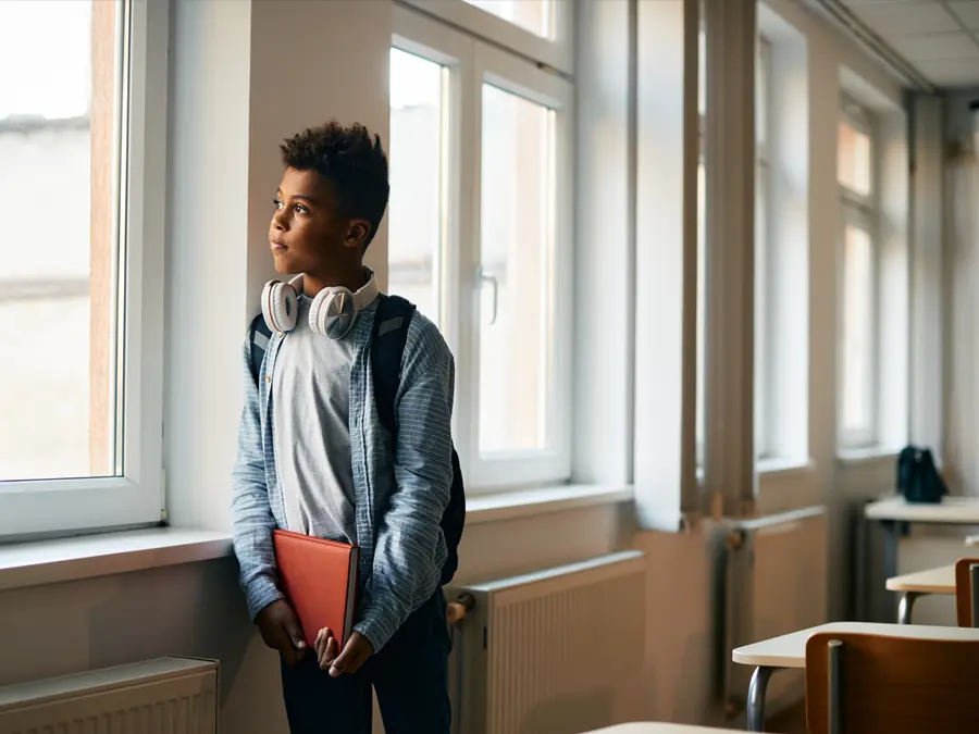 Boy looking out a school window