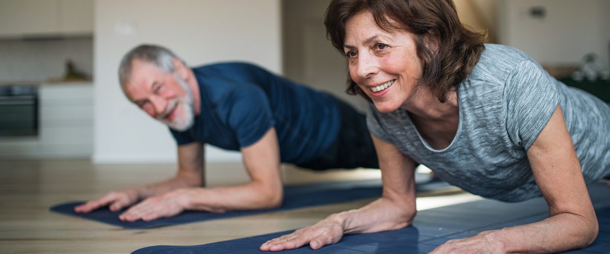 Two older people in a plank position.