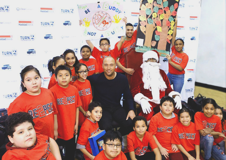 Derek Jeter with children in a  Turn 2 Foundation holiday event