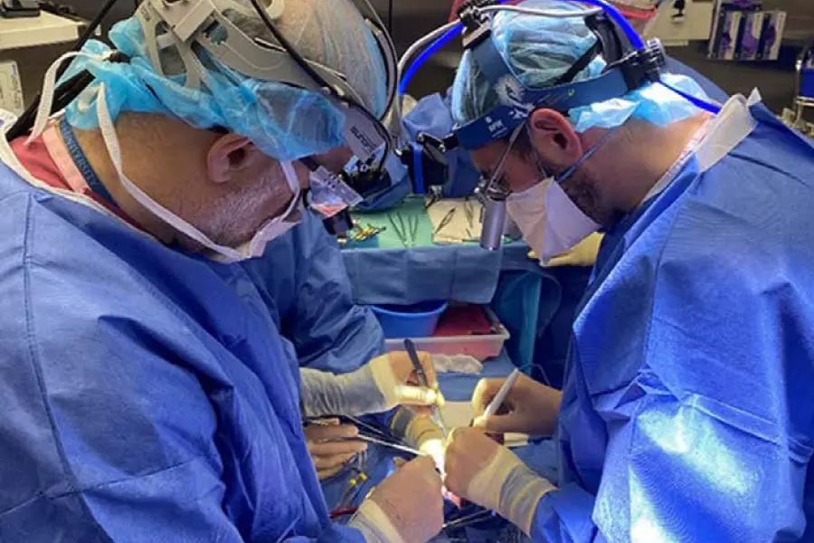 Drs. Emile Bacha and David Kalfa (NewYork‑Presbyterian/Columbia) preparing the new valves for two month- old Brooklyn during the partial heart transplant