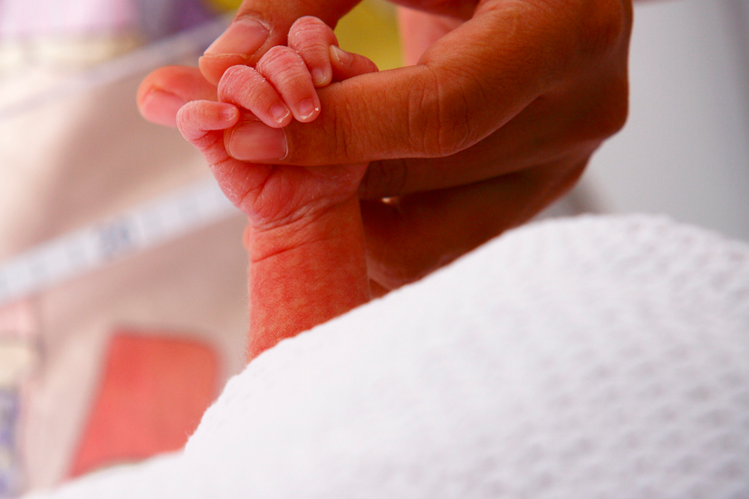 Nicu patient hand being held in incubator