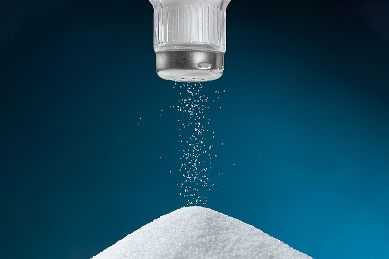 image of salt shaker shaking salt into a pile
