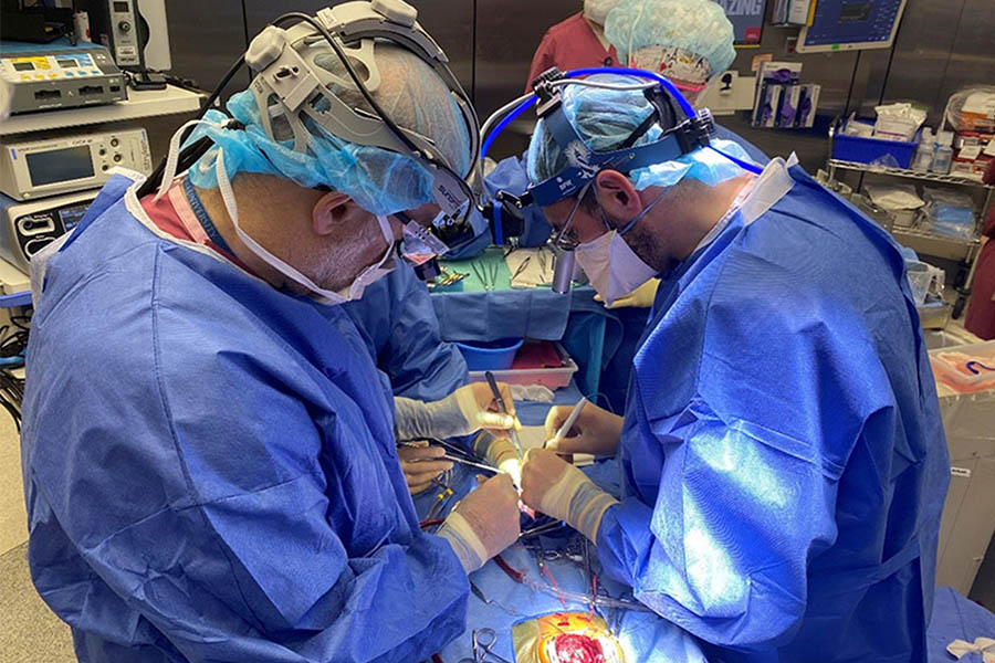 Drs. Emile Bacha and David Kalfa (NewYork‑Presbyterian/Columbia) preparing the new valves for twomonth- old Brooklyn during the partial heart transplant