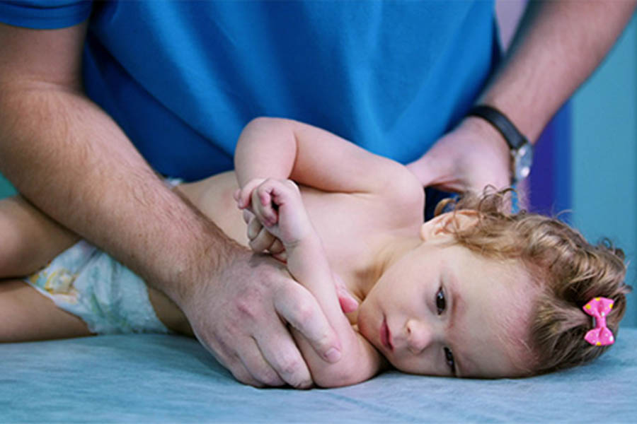 A toddler with cerebral palsy having occupational therapy