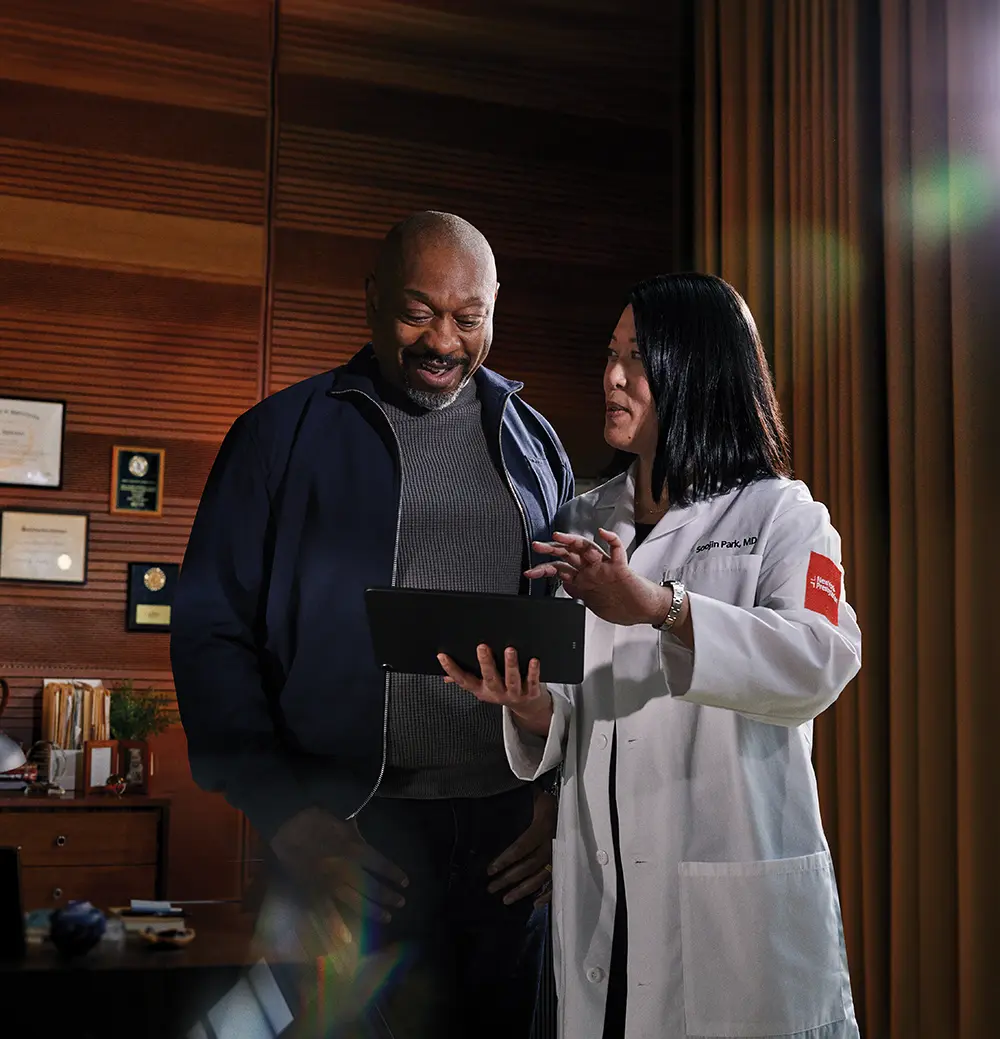 doctor showing something to a patient on a tablet