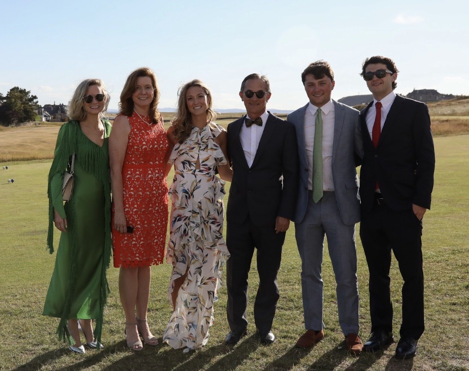Dr. Chabot standing next to his family in a grass field