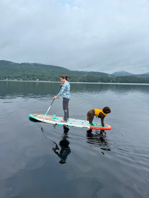 Dr. Hoffman on a lake with her dog.