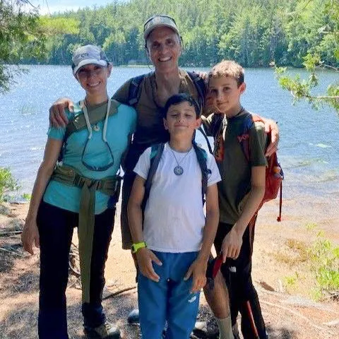 Dr. Hoffman with her family in front of a lake.