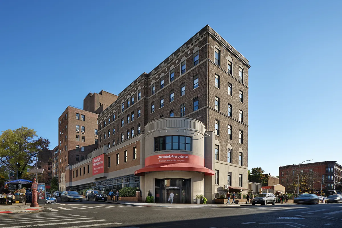 Father walking with children on sidewalk