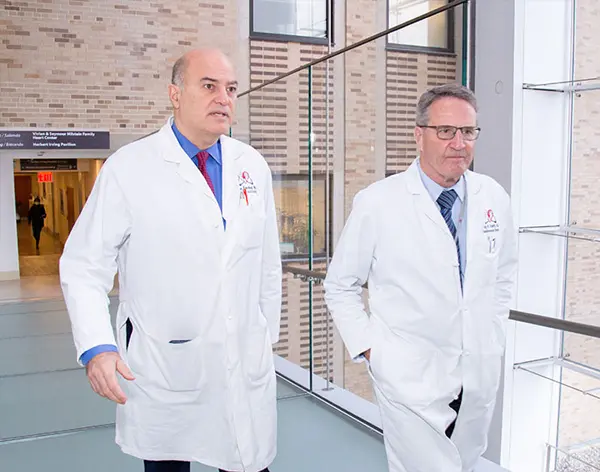 Two cardiac surgeons walking down the hallway 