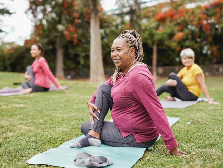 A group of women exercising in a park.