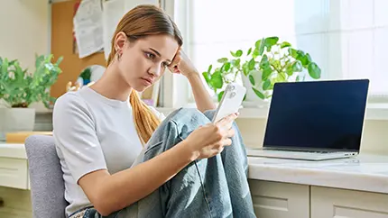 Young female adult looking at her phone