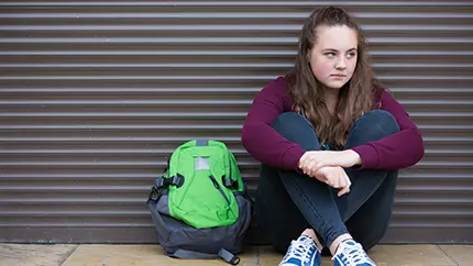 young girl sitting on the ground