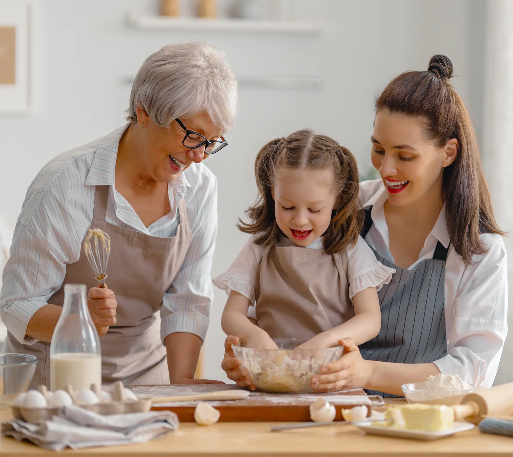 family group photo with daughter mother and grandmother baking