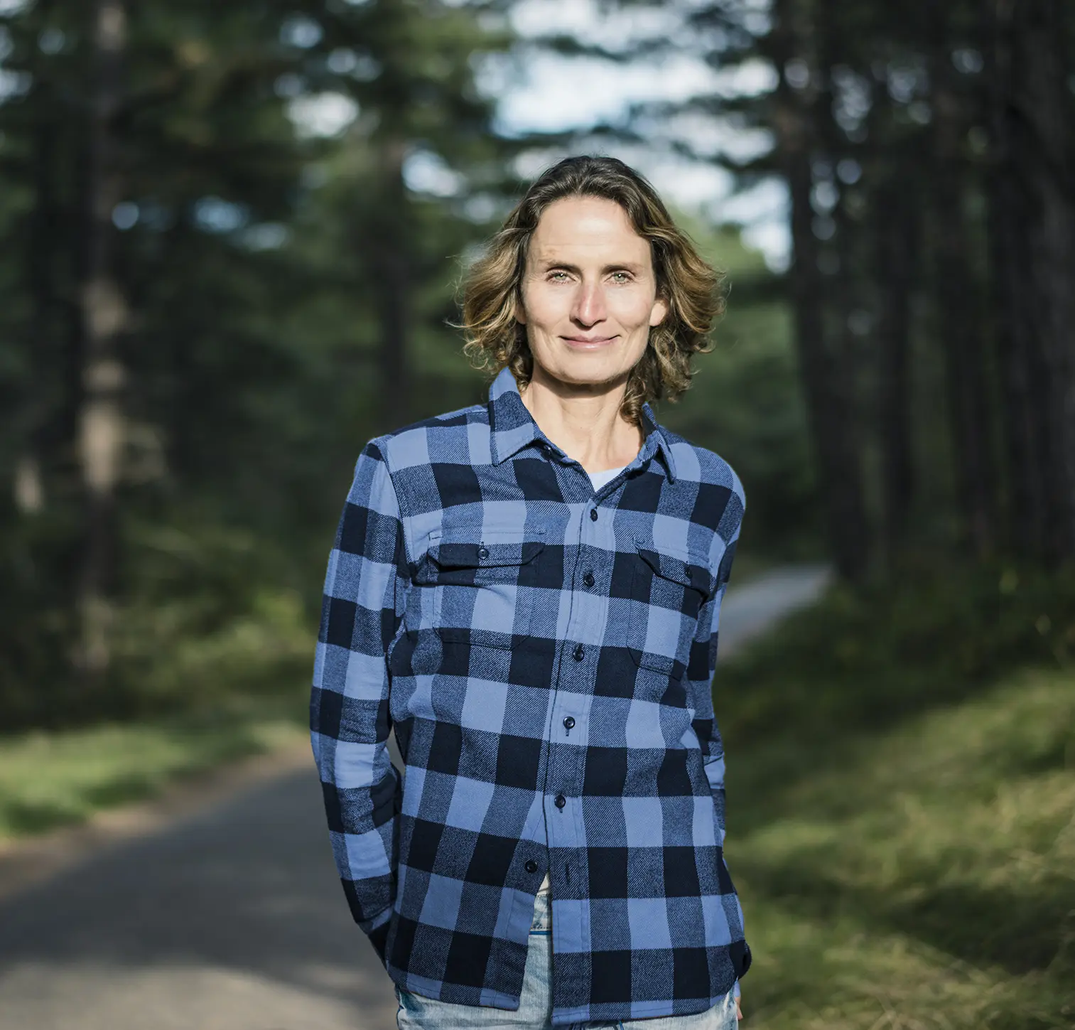 woman standing in the woods