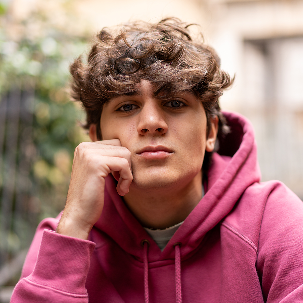 teenage boy sitting on a stoop
