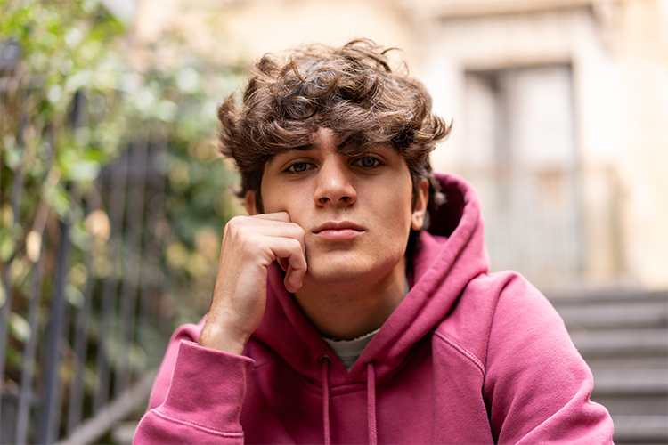 teenage boy sitting on a stoop