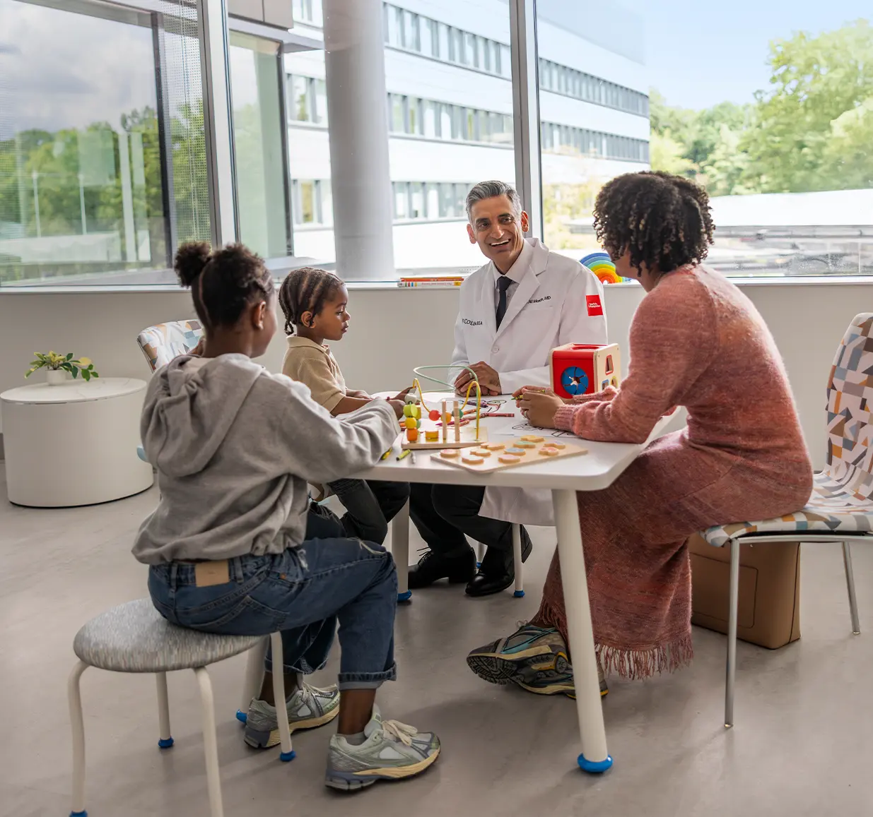 Dr sitting with kids and family