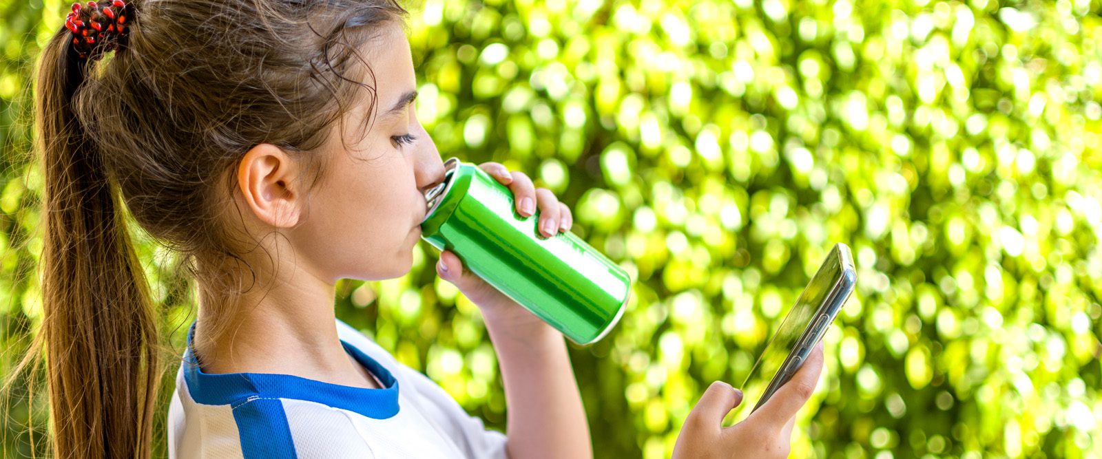 Girl sipping from a canned drink