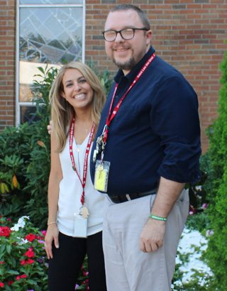 Lauren Crupi and Mike Daneman stand in front of the New Jersey school where they both teach.