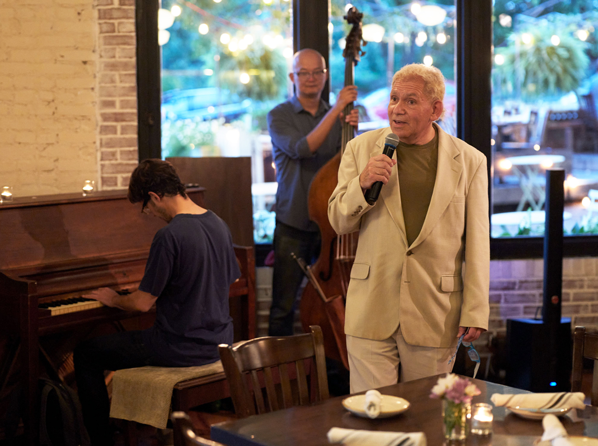 Henry Ray Fischbach performing with his band at The Inwood Farm