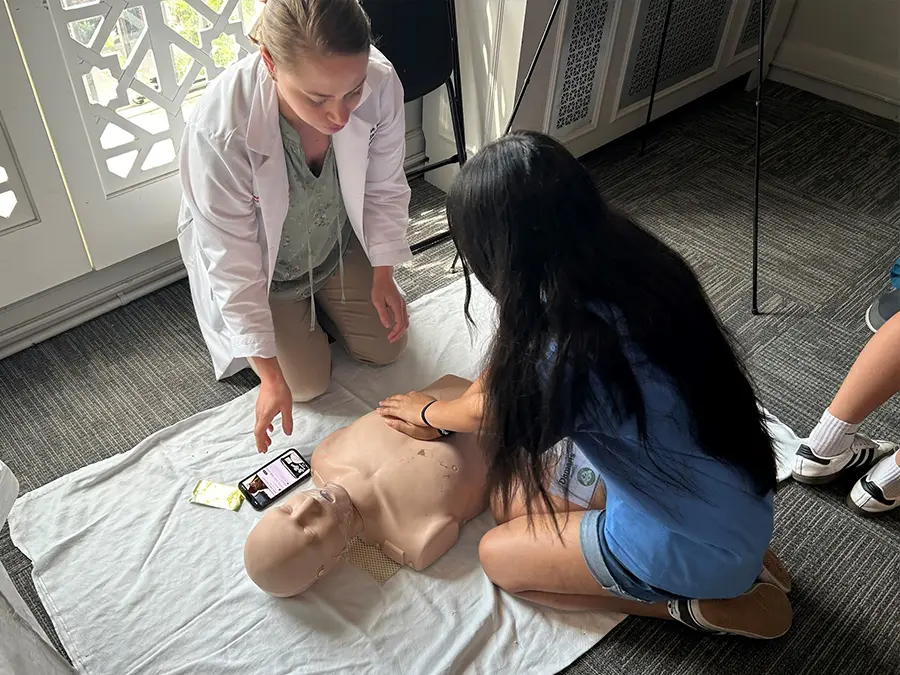 Young girl learning CPR