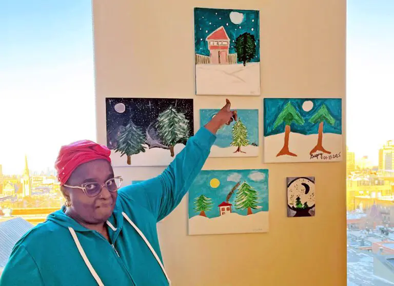 Pat Boyce-Jones proudly displays her painting on the wall at NewYork-Presbyterian Brooklyn Methodist Hospital’s art initiative.