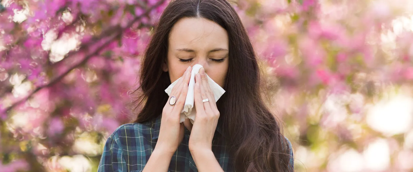 Woman blowing her nose.