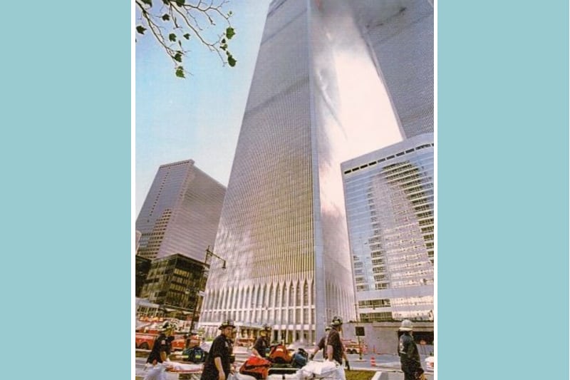 Moments before the South Tower collapsed, a photographer took this photo of a group of NewYork-Presbyterian paramedics and EMTs at the tower’s base. His warning to run saved their lives.