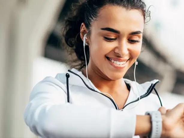 a female jogger looking at her watch