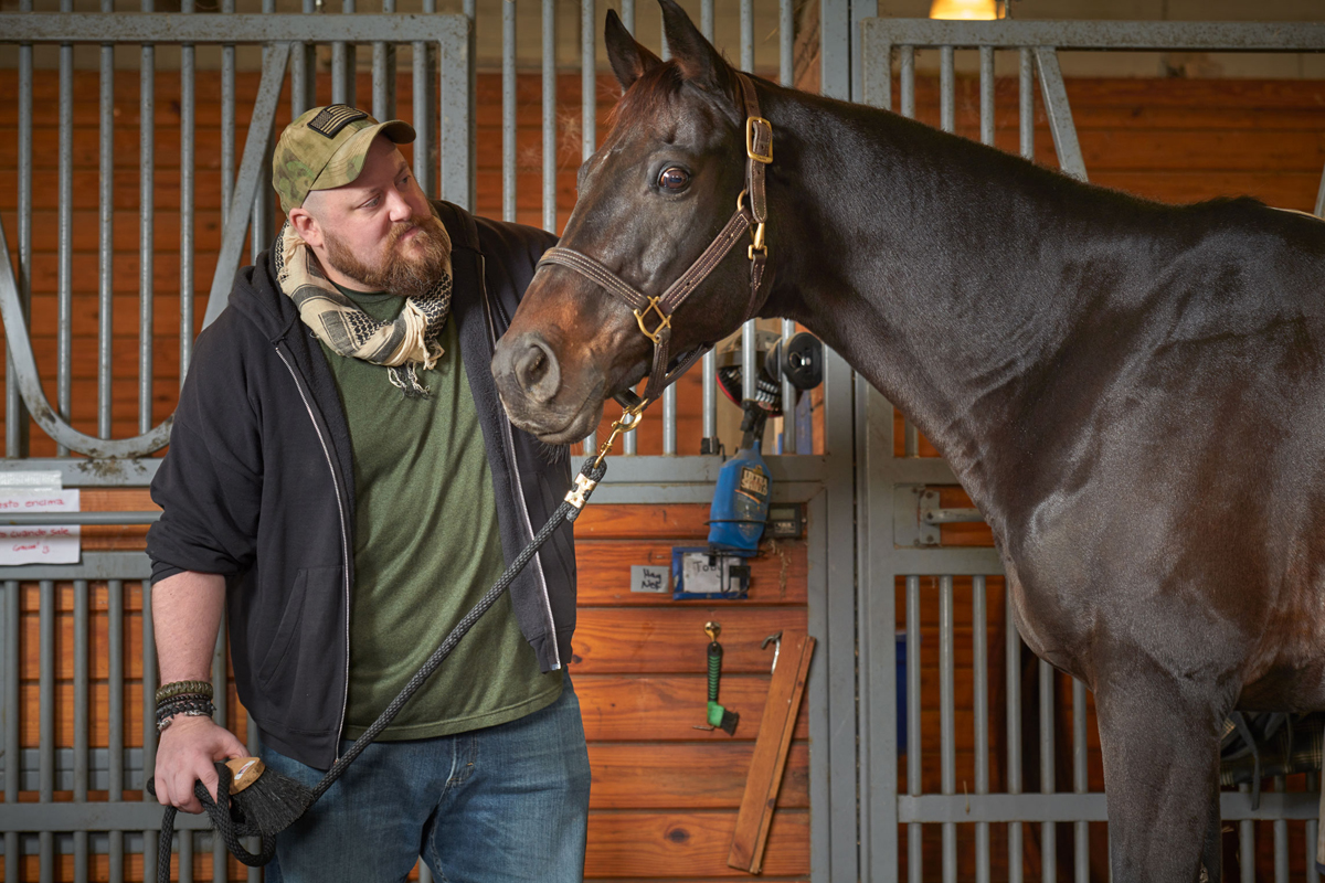 Marine Corps veteran Matthew Ryba leads therapy horse Crafty Star out of the stable at the Bergen Equestrian Center.