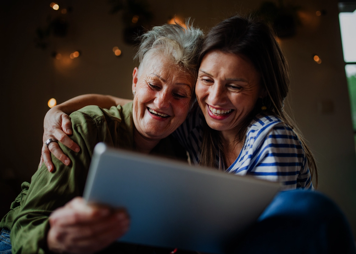 Mom and daughter happy in front of screen