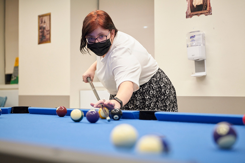 girl playing a game of pool