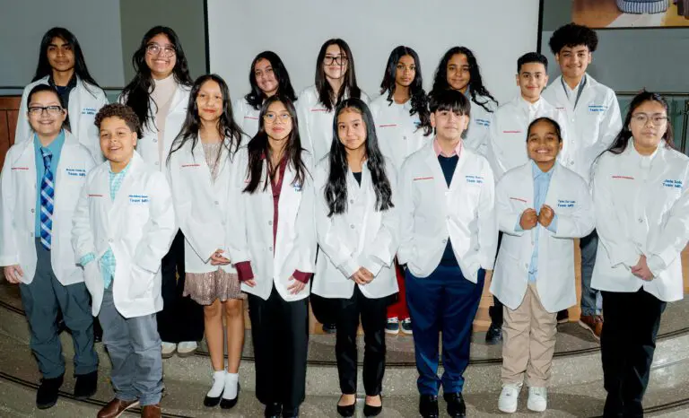A middle-school class of Lang Youth scholars at the white coat ceremony in 2025.