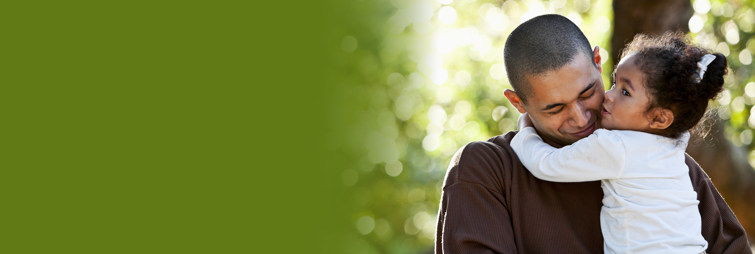 Father embracing daughter in a park