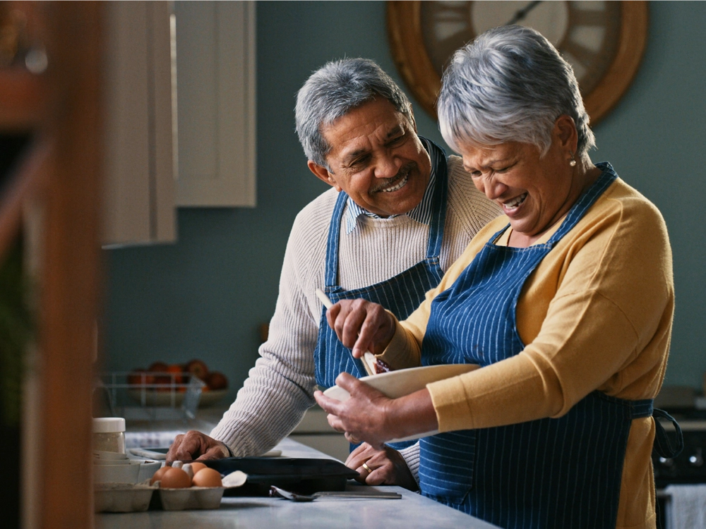 Elderly couple cooking together