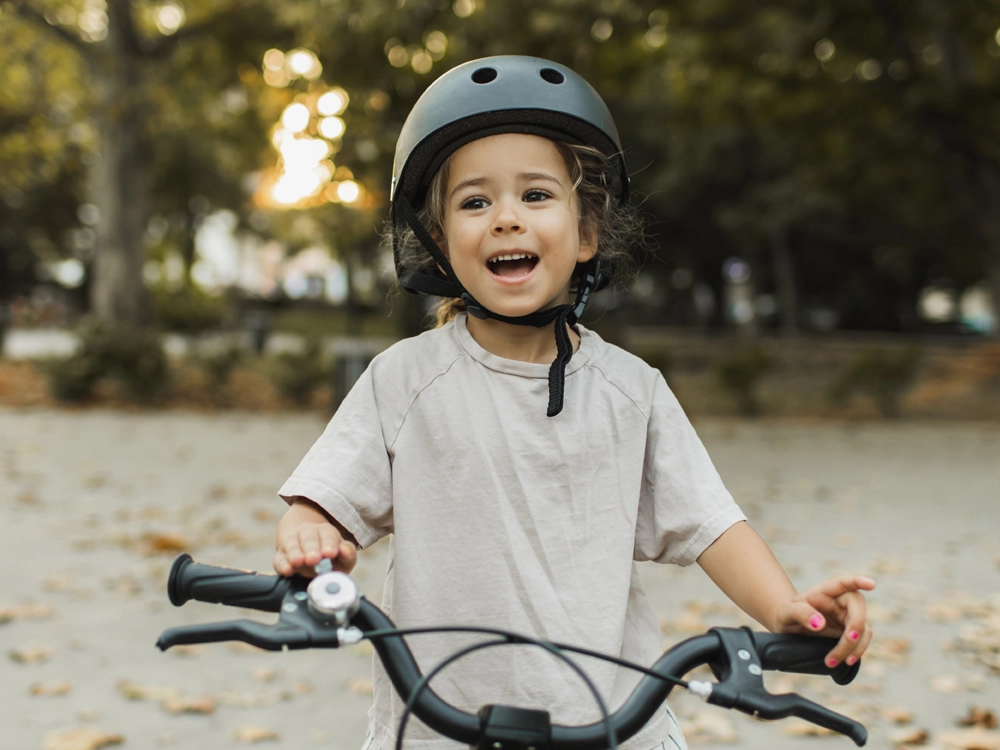 Young boy wearing a helmet while riding a bike
