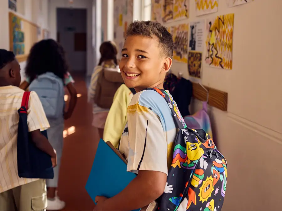 boy walking down school hallway