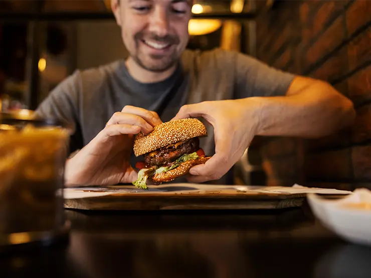 image of guy picking up a burger